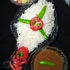 A picture of Khatte Masar with boiled rice 🍽.
