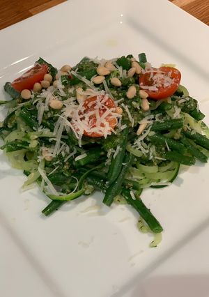 A picture of Courgetti with pesto and green beans.