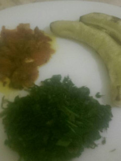 A picture of Matoke served with steamed spinach and tomato paste.