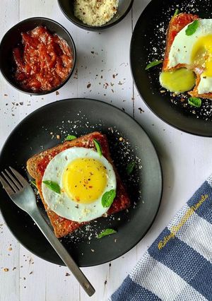 A picture of Marinara sunny side up egg toast.