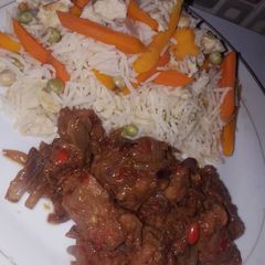 A picture of White rice with veggies and stew.