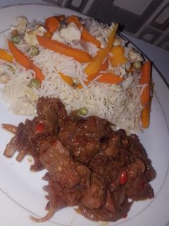 A picture of White rice with veggies and stew.