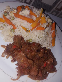 A picture of White rice with veggies and stew.