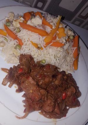 A picture of White rice with veggies and stew.