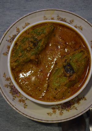 A picture of Potoler dorma (stuffed pointed gourd curry).