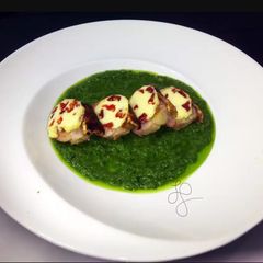 Roasted Pork Top Sun Dried Tomato Butter On Pesto Sauce A picture of Roasted Pork Top Sun Dried Tomato Butter On Pesto Sauce.