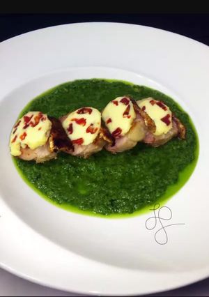 A picture of Roasted Pork Top Sun Dried Tomato Butter On Pesto Sauce.
