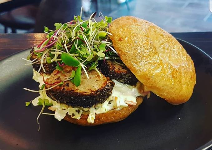 Herb crusted pork fillet and coleslaw on a bun