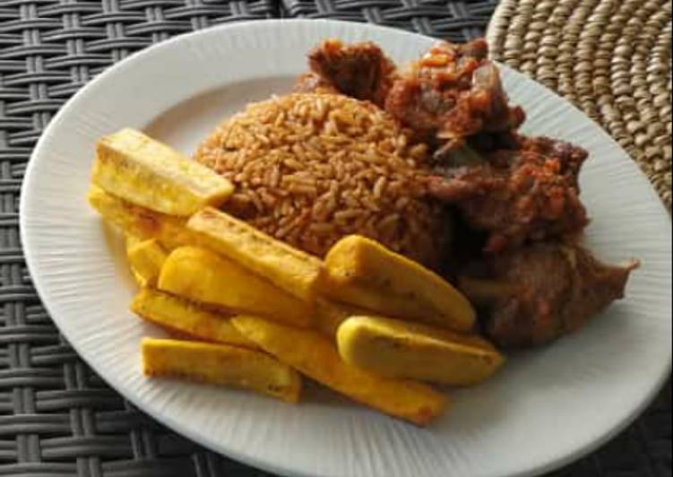 Jollof rice with fried yam and peppered meat