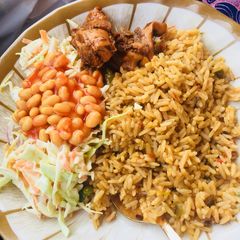 A picture of Jollof rice,salad and grilled chicken.