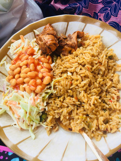 A picture of Jollof rice,salad and grilled chicken.