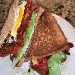 A picture of BLT with fried egg.