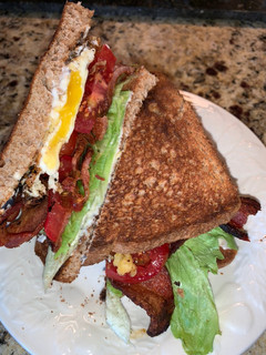 A picture of BLT with fried egg.