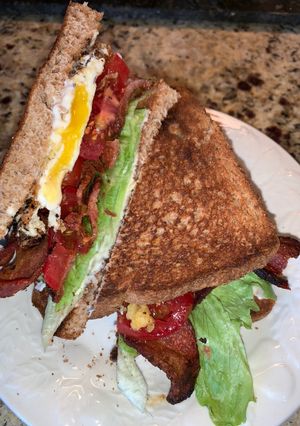 A picture of BLT with fried egg.