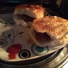 A picture of Burger with corn Potatoes filling.