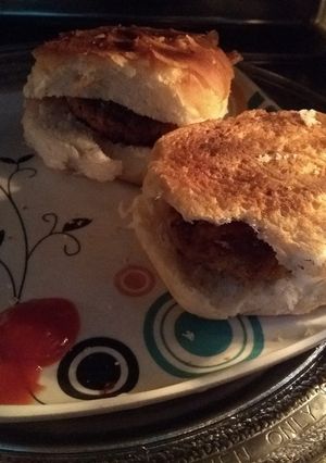 A picture of Burger with corn Potatoes filling.