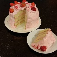 A picture of White Chocolate Layer Cake Filled with Strawberry Mousse and Frosted with Whipped Strawberry White Chocolate Ganache.