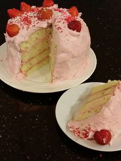 A picture of White Chocolate Layer Cake Filled with Strawberry Mousse and Frosted with Whipped Strawberry White Chocolate Ganache.
