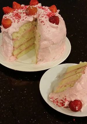 A picture of White Chocolate Layer Cake Filled with Strawberry Mousse and Frosted with Whipped Strawberry White Chocolate Ganache.
