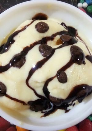 A picture of Vanilla ice cream with chocolates sauce.