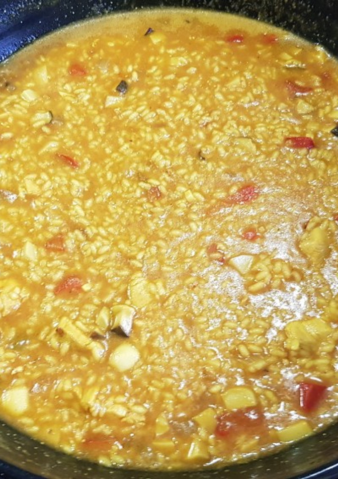 Una foto de Arroz caldoso de pollo de corral y boletus