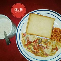 A picture of Bread & fried eggs with a cup of tea.