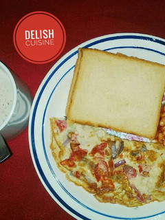 A picture of Bread & fried eggs with a cup of tea.