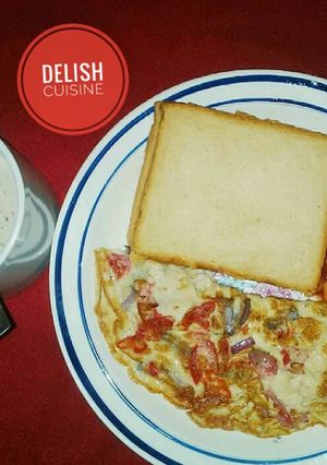 A picture of Bread & fried eggs with a cup of tea.