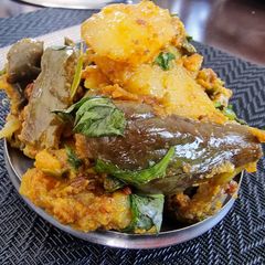 A picture of Stuffed brinjals and potato curry in pressure cooker.