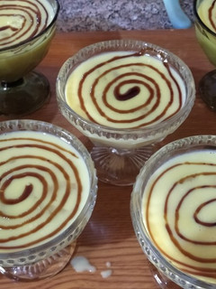 A picture of Vanilla Flan with Grapes and Caramel.