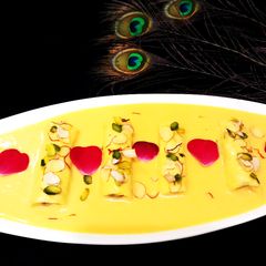 Mango Rabdi With Chocolate Dry Fruit Roll A picture of Mango Rabdi With Chocolate Dry Fruit Roll.