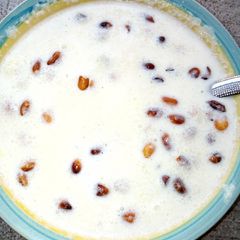 A picture of Garri with milk and peanuts.