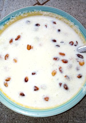 A picture of Garri with milk and peanuts.