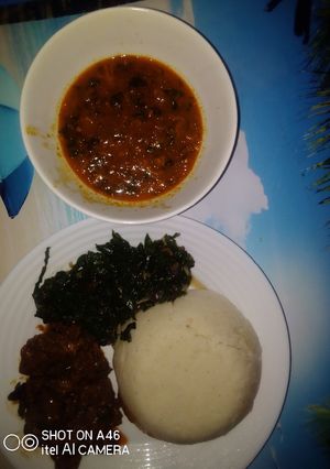 A picture of Goat meat wetfry served with ugali n spinach.