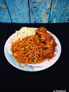 A picture of Brown spaghetti with peppered meat and coslaw.
