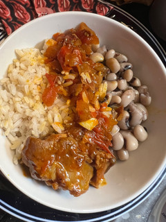A picture of Goat with rice and beans.
