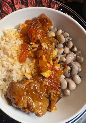 A picture of Goat with rice and beans.