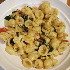 A picture of Pasta with roasted cauliflower, spinach and prosciutto.