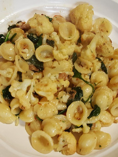 A picture of Pasta with roasted cauliflower, spinach and prosciutto.