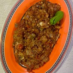 A picture of Baingan ka bharta (with roasting method).