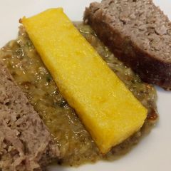 A picture of Ham and Parmesan meatloaf with polenta and mushroom sauce.