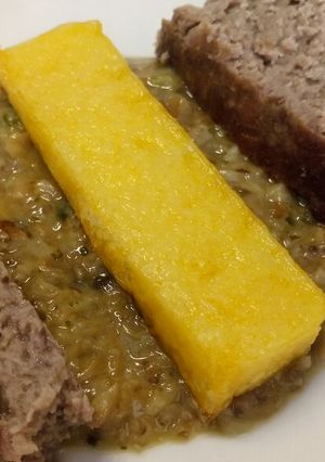 A picture of Ham and Parmesan meatloaf with polenta and mushroom sauce.