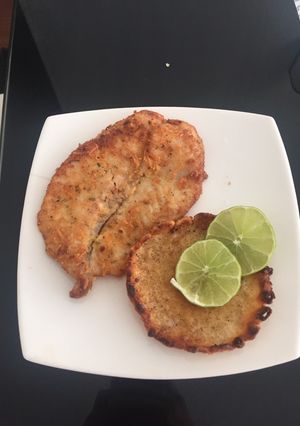 Una foto de Filete de pescado apanado con queso parmesano y orégano