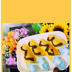Mango pops with chocolate sauce A picture of Mango pops with chocolate sauce.