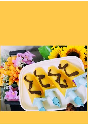 A picture of Mango pops with chocolate sauce.