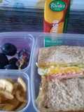 Egg sandwiches banana chips and grapes