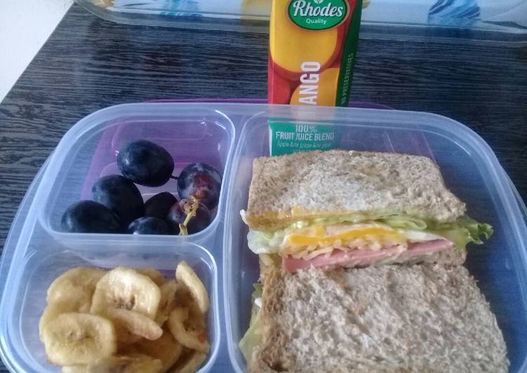 Egg sandwiches banana chips and grapes