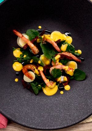 A picture of Palm heart, shrimp, watercress and confit tomato in extra virgin olive oil from Spain salad.
