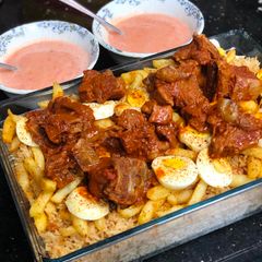 A picture of Kabsa rice with tandoori chops.