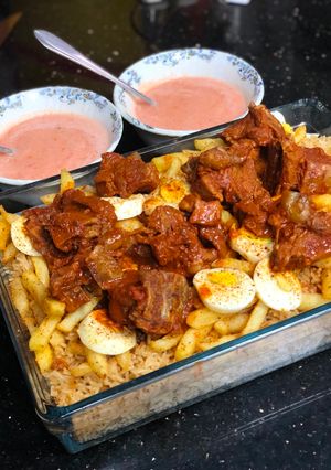 A picture of Kabsa rice with tandoori chops.